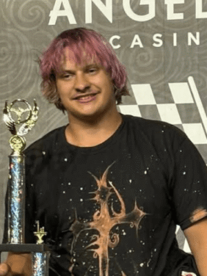 Dakota Wilkinson standing on the podium with his trophy after winning 60 minutes of fear